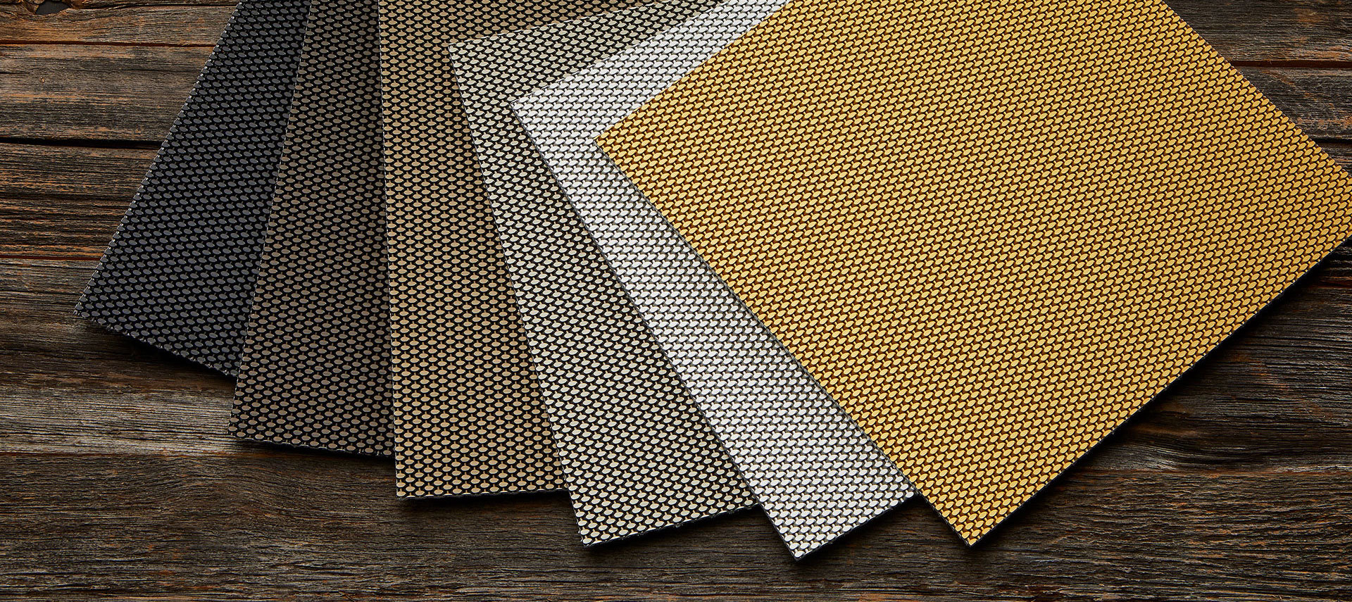 Range of woven metal mesh samples in different finishes and patterns