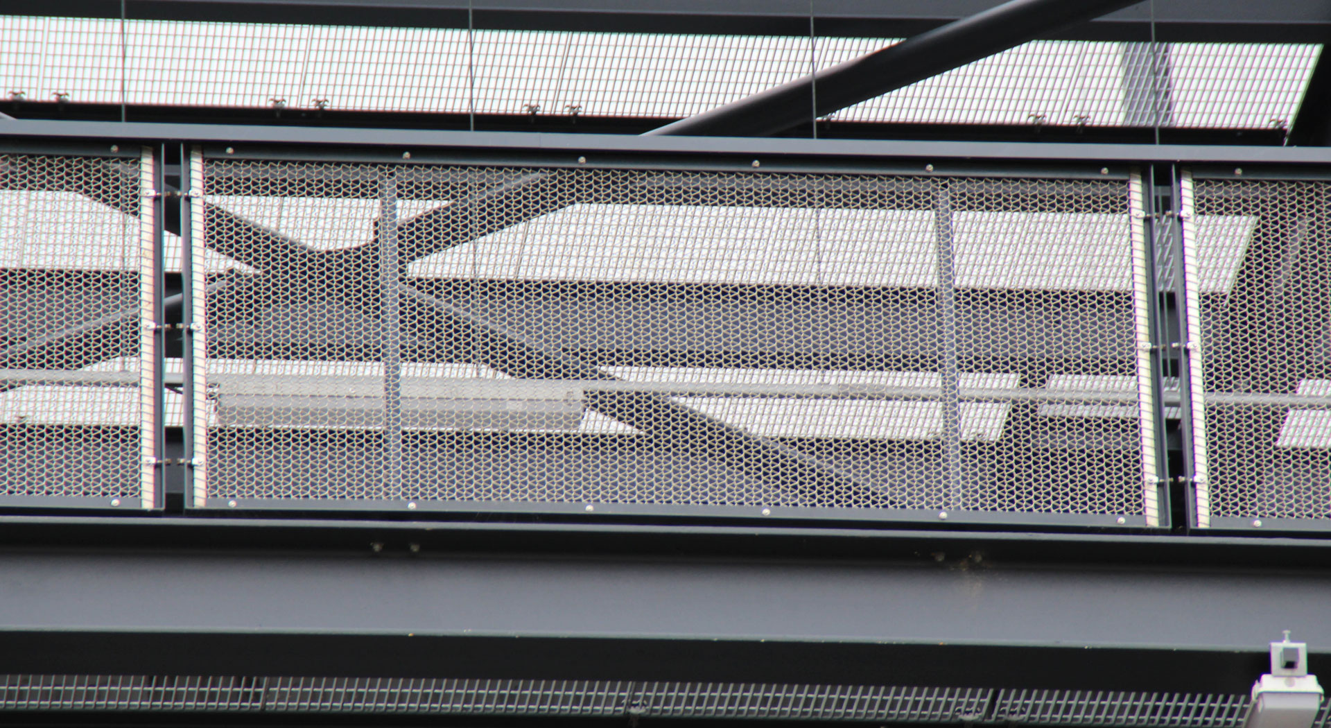 Metal mesh balustrade panels on external walkway at Gantry East London development