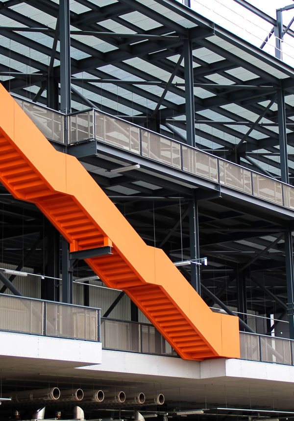 External staircase and structural steel frame with metal mesh balustrade at Gantry East London