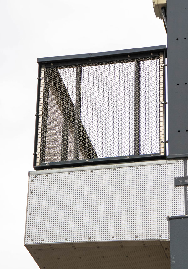 Balcony detail with architectural metal mesh balustrade on residential façade