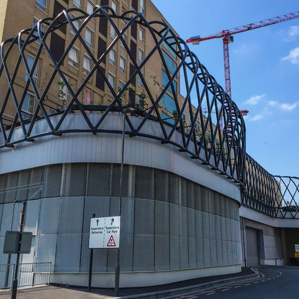 Expanded metal mesh façade detail at Hallsville Quarter with architectural framework