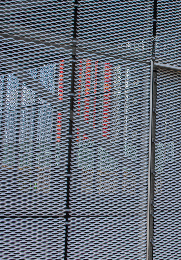 Close-up of expanded metal mesh façade panels at Hallsville Quarter development