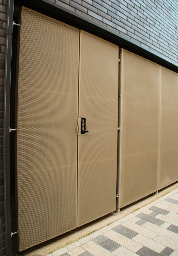 Perforated metal panel façade with integrated door access system.