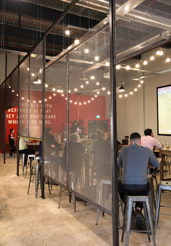 Expanded mesh divider in food hall setting