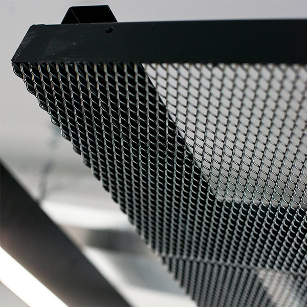 White ceiling with a black mesh grid panel