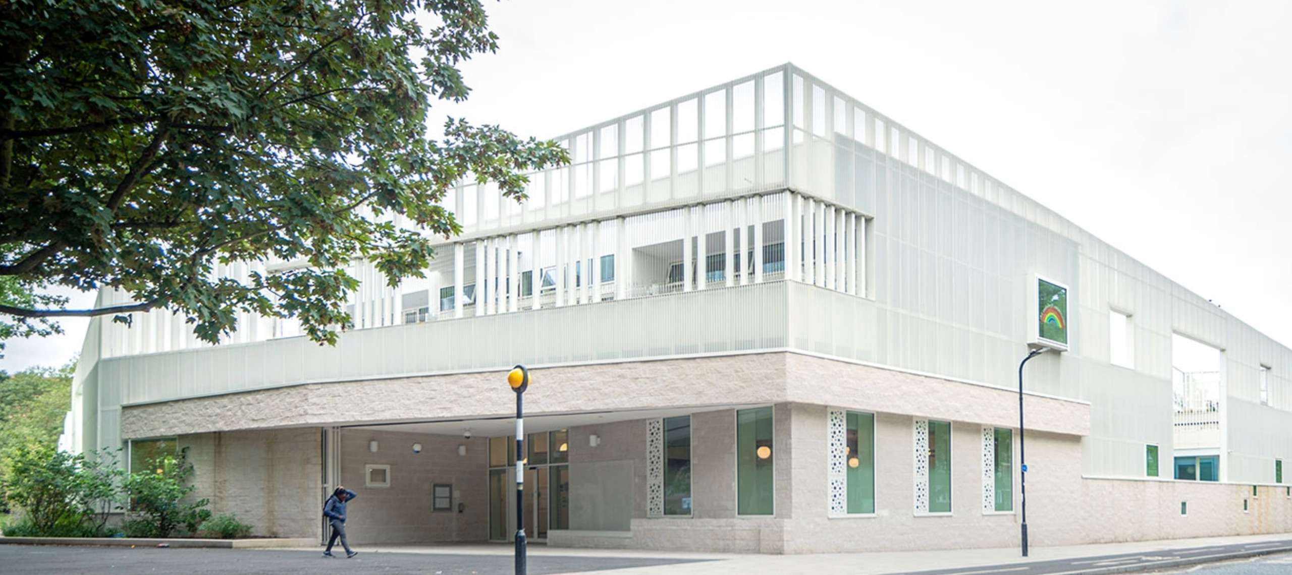 A school with a white cladding facade