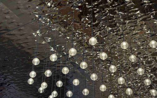 An AC300W ceiling system with a shiny reflective water ripple sheet