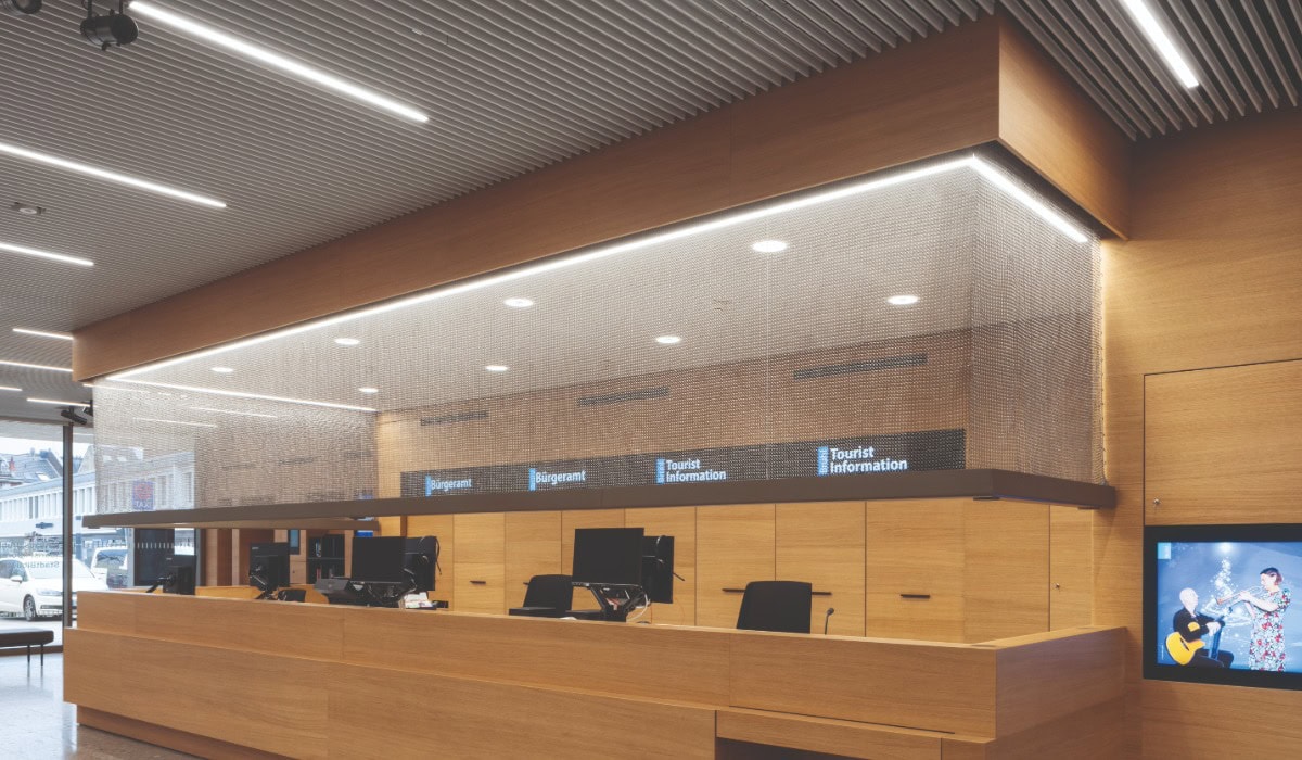 A brown reception with computer monitors and a grey Alpha Mesh layover
