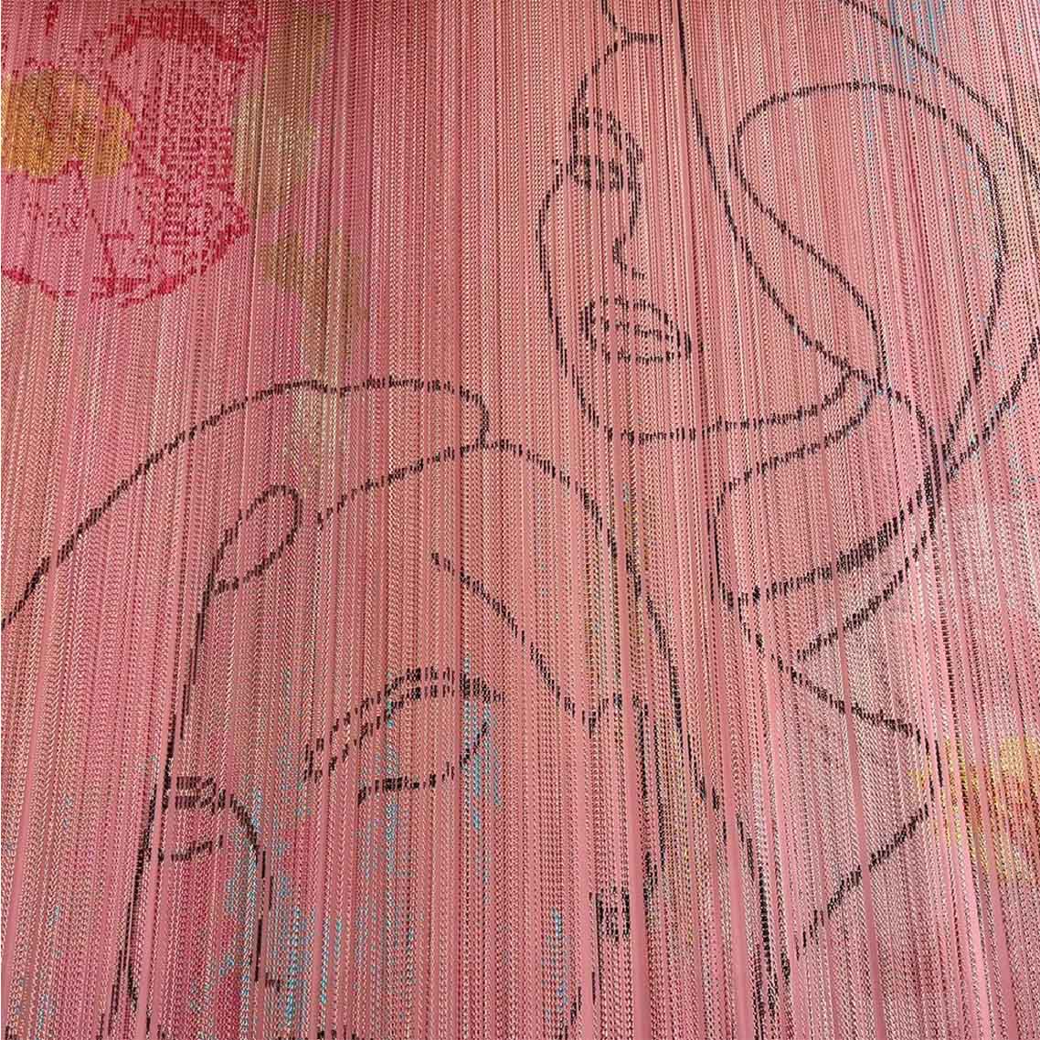 a close up of pink Kriskadecor metal chain drapery, with black powder coated links inserted into the drapery to create line drawn faces. 