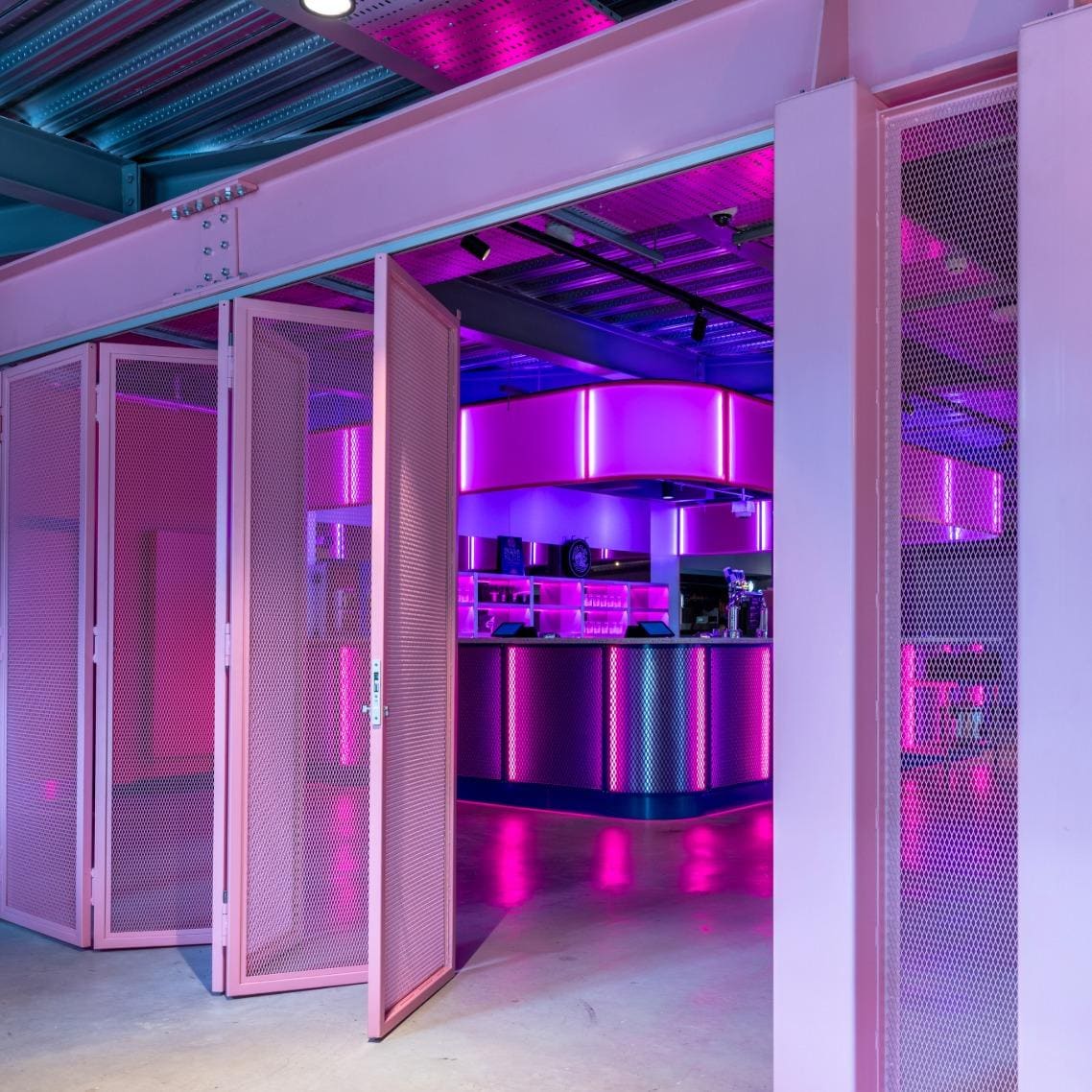 A close up of the pink mesh gate system with the door partially open