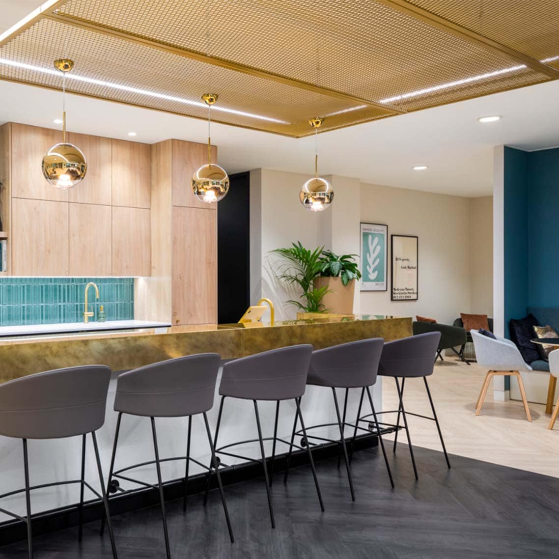 a close up of the dinning are with the gold metal kitchen top and gold AC400 ceiling system.