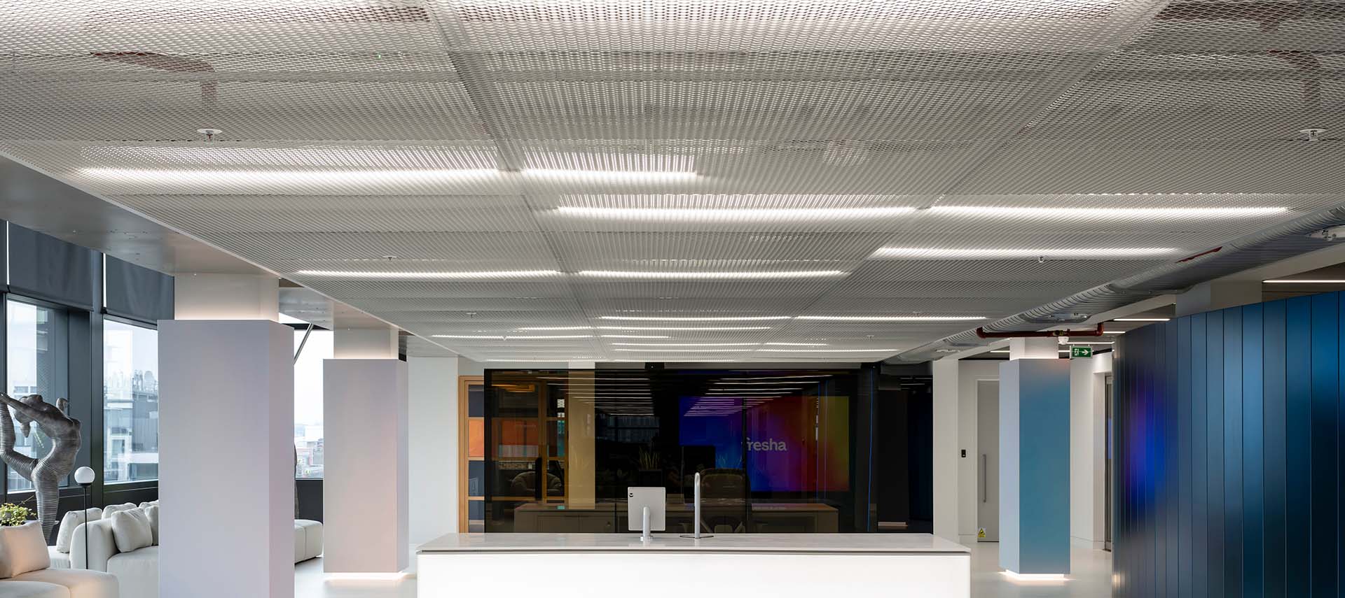 A white expanded mesh ceiling in a commercial office space, similar to Zentia's DecoMesh Range