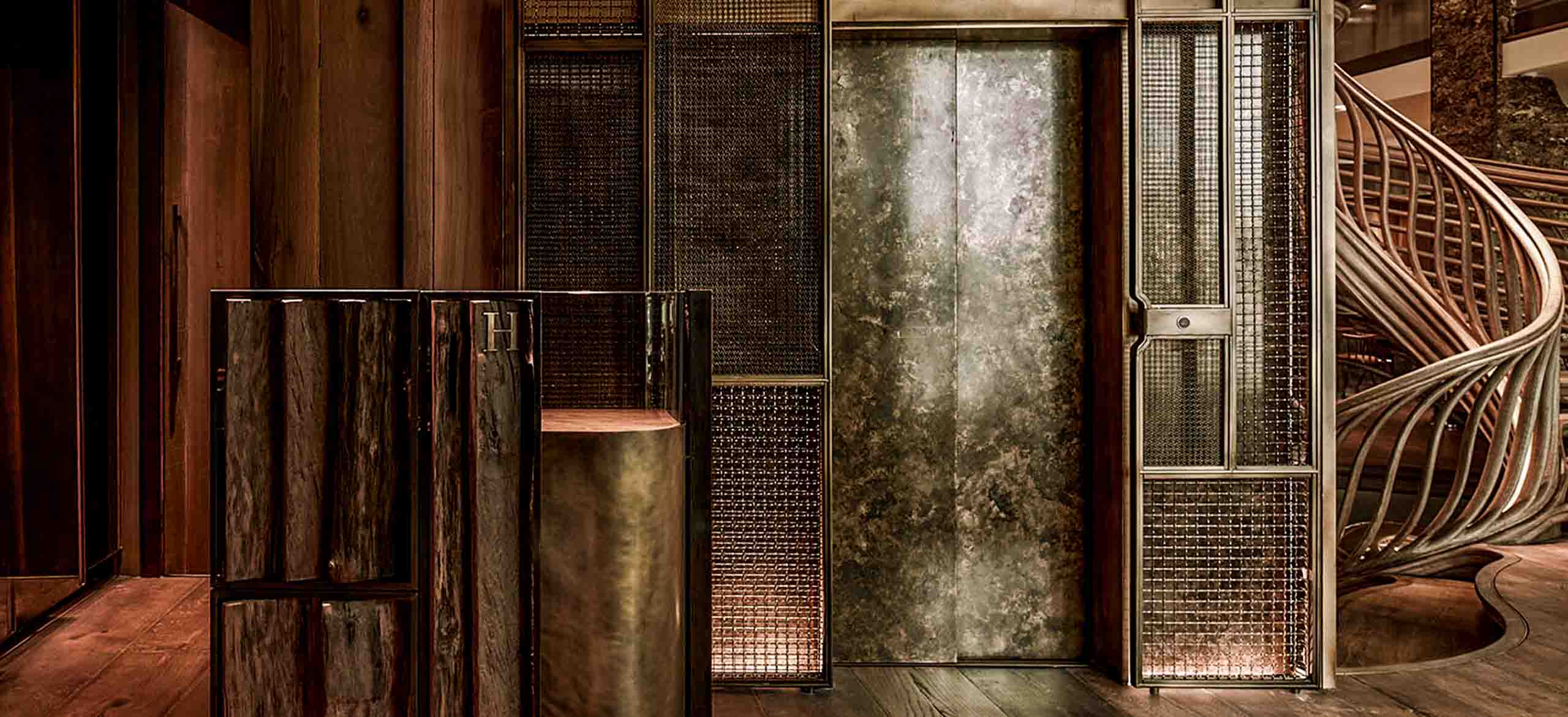 A woven mesh lift enclosures at HIDE restaurant in London. With two antique brass woven mesh woven together.